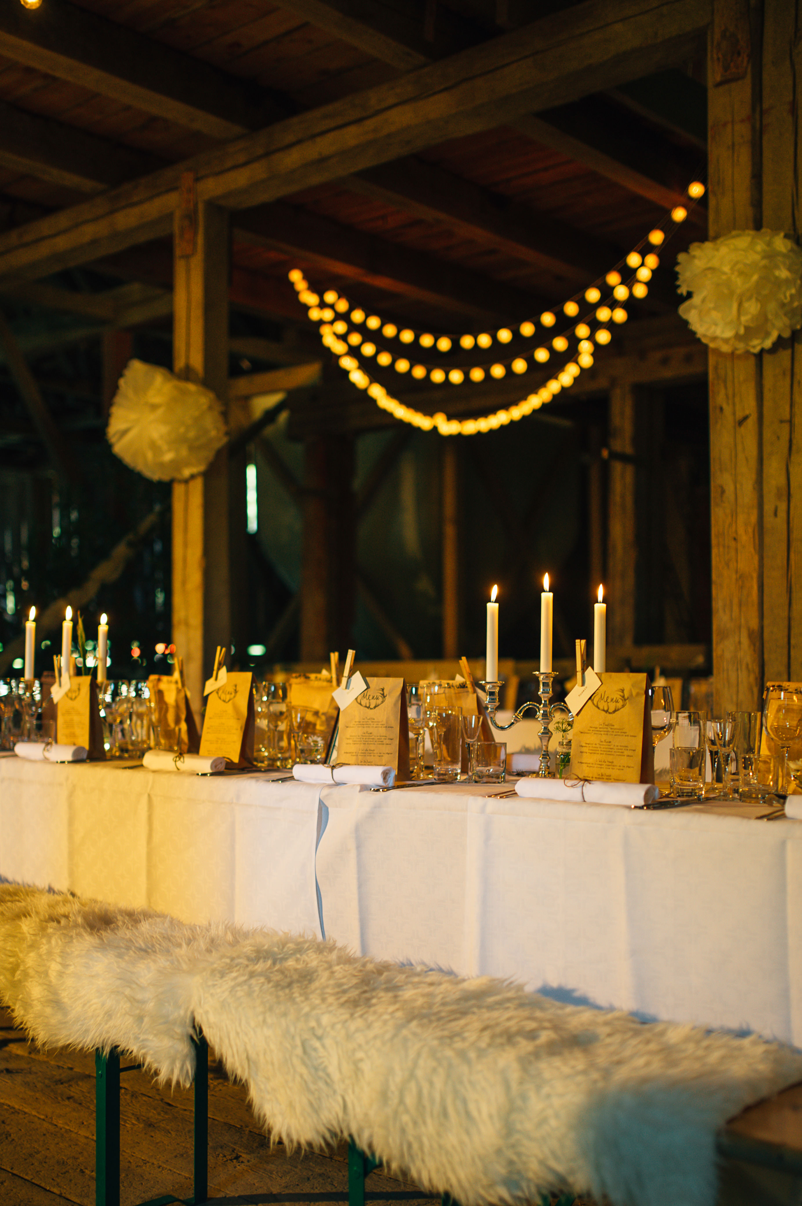 Candlelit barn reception atmosphere at Beckershof Sweden