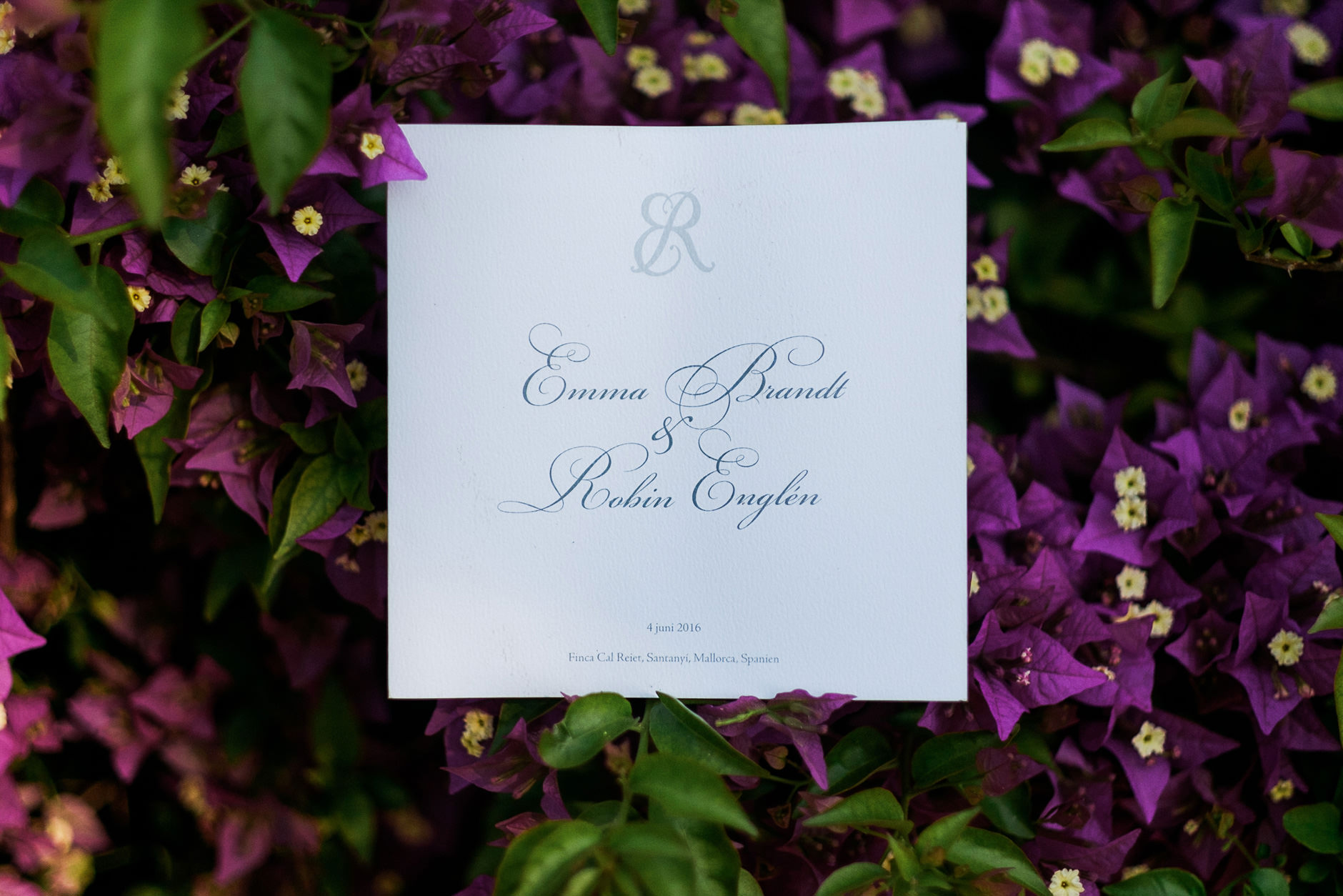 Emma and Robin's wedding invitation among bougainvillea, Mallorca