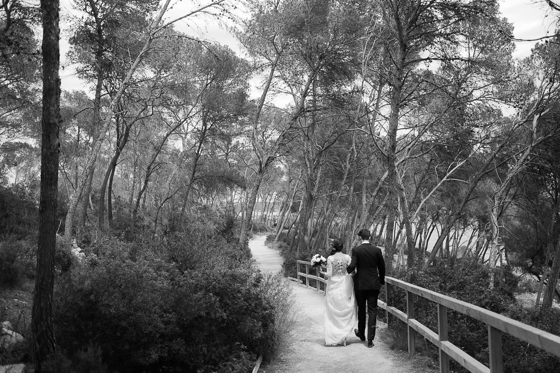 Bride and groom walking through the woods, Mallorca wedding portraits