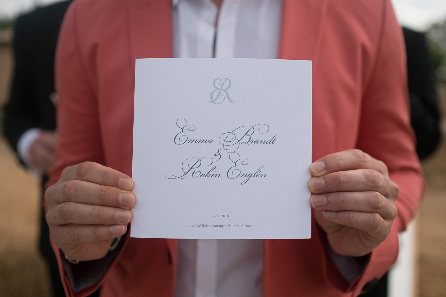 The groom holding the wedding invitation, Mallorca wedding