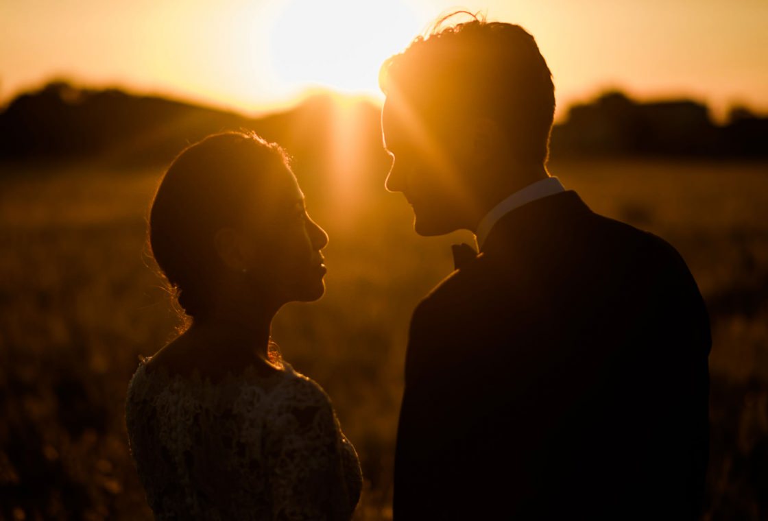 Bride and groom kissing in silhouette at golden hour, a Mallorca wedding