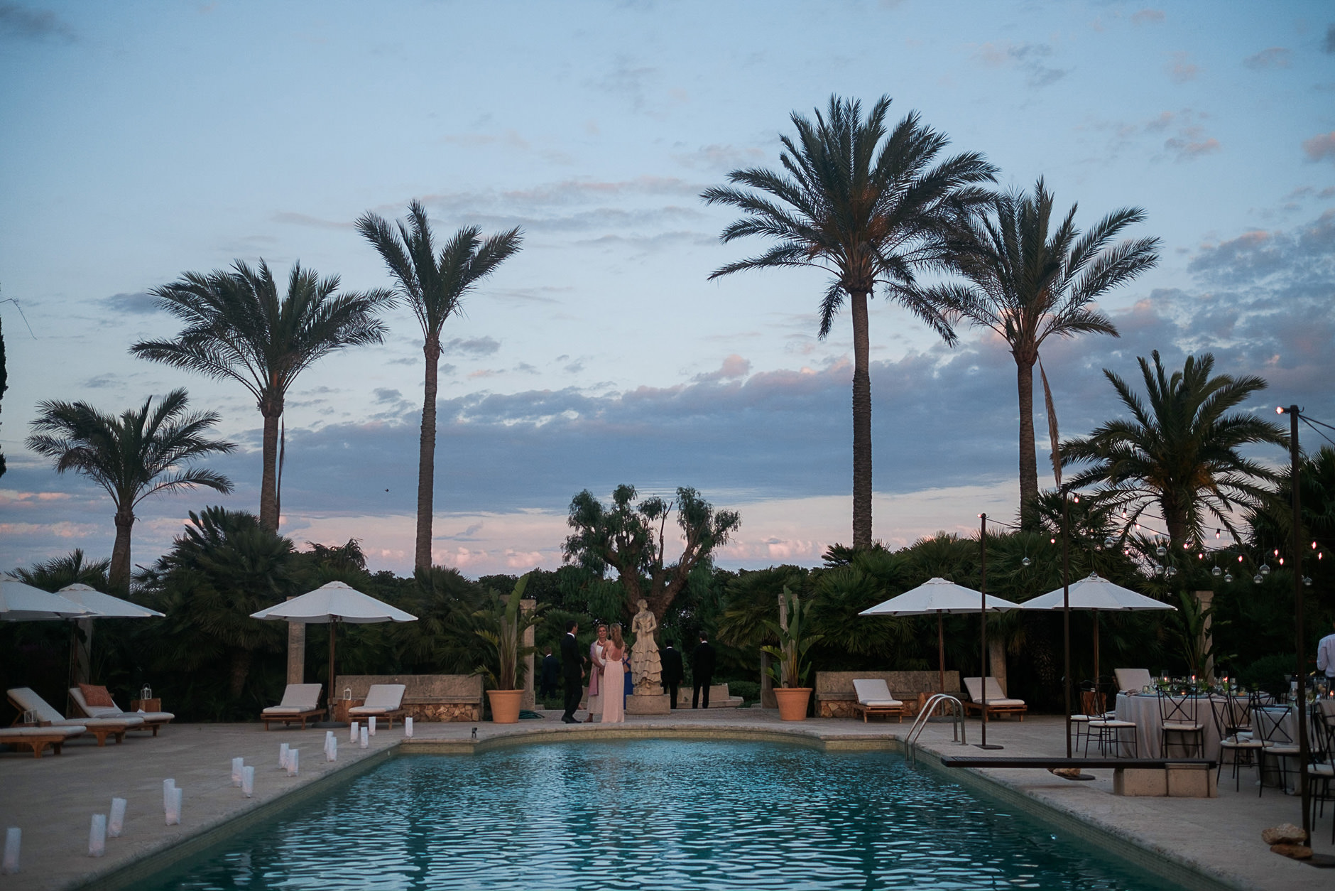 The finca pool and palms at dusk, Mallorca wedding venue