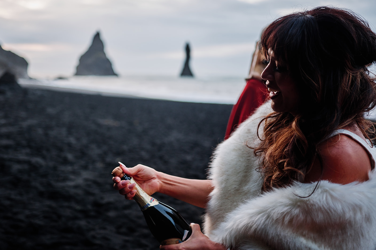 Couple walking on black sand beach during south Iceland elopement