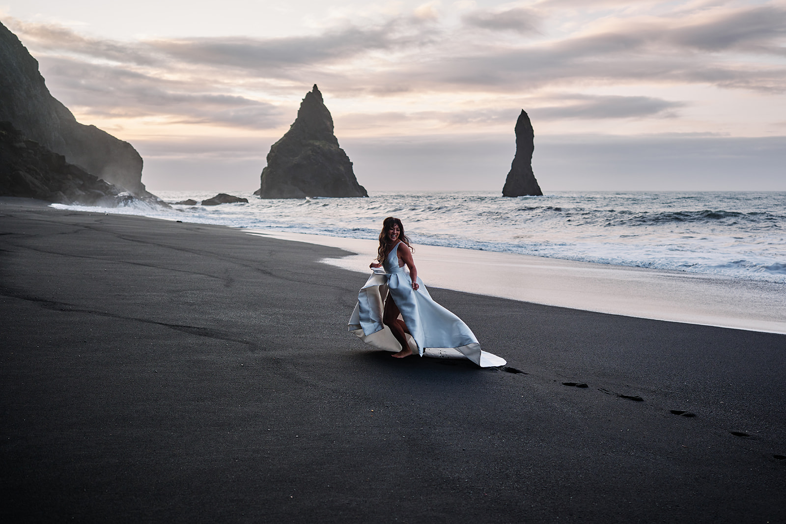 Leaving Reynisfjara at sunrise with waves and black sand behind