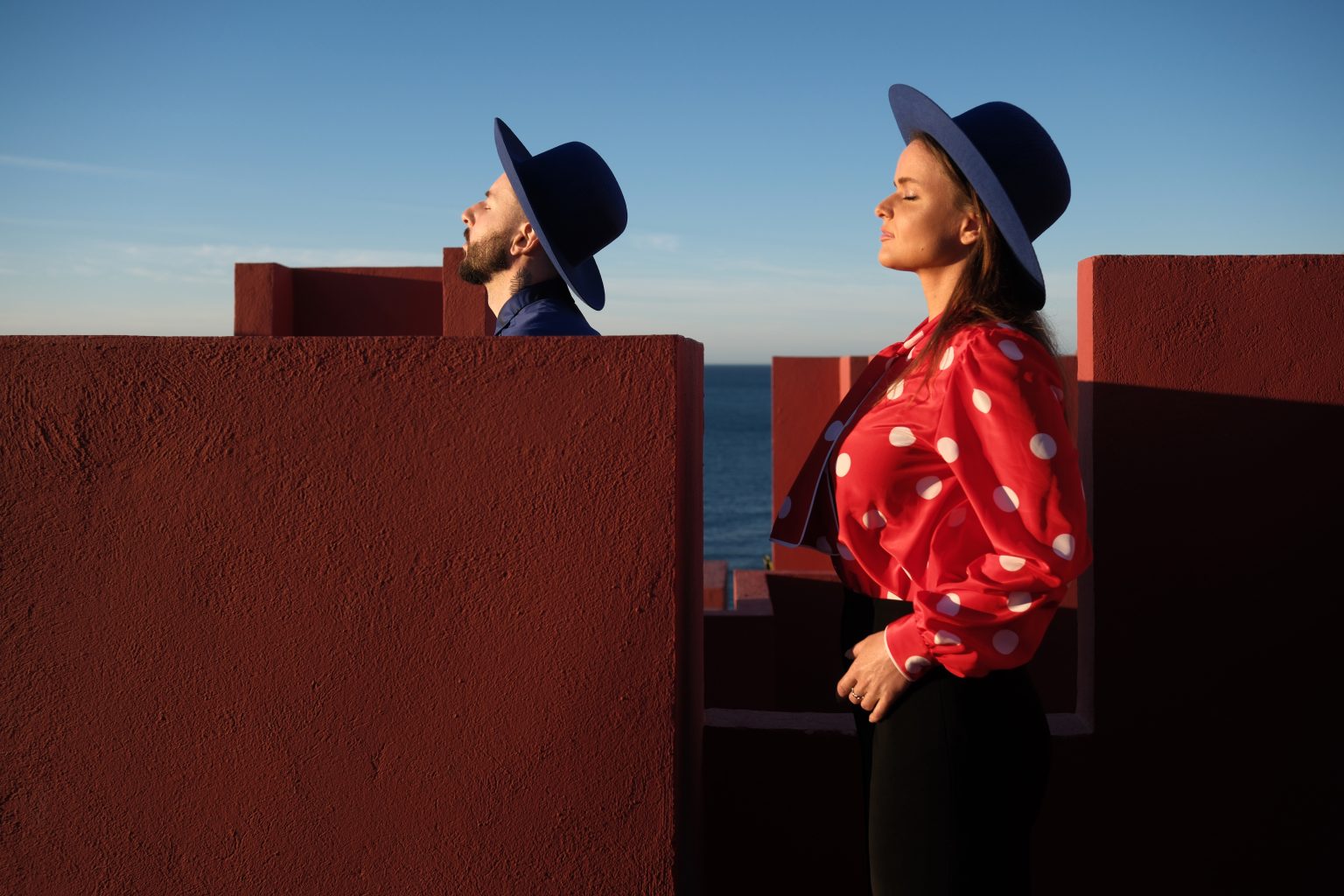 Adriana in profile on the rooftop of Muralla Roja with the Mediterranean behind
