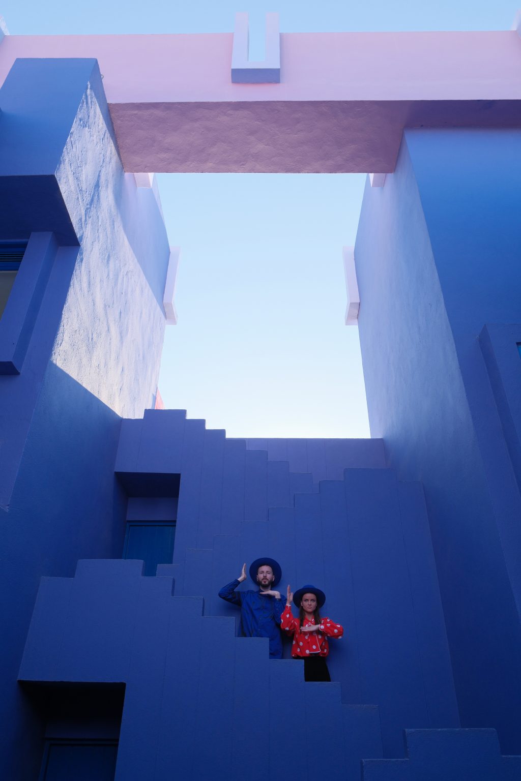 Looking up through the blue courtyard geometry of La Muralla Roja