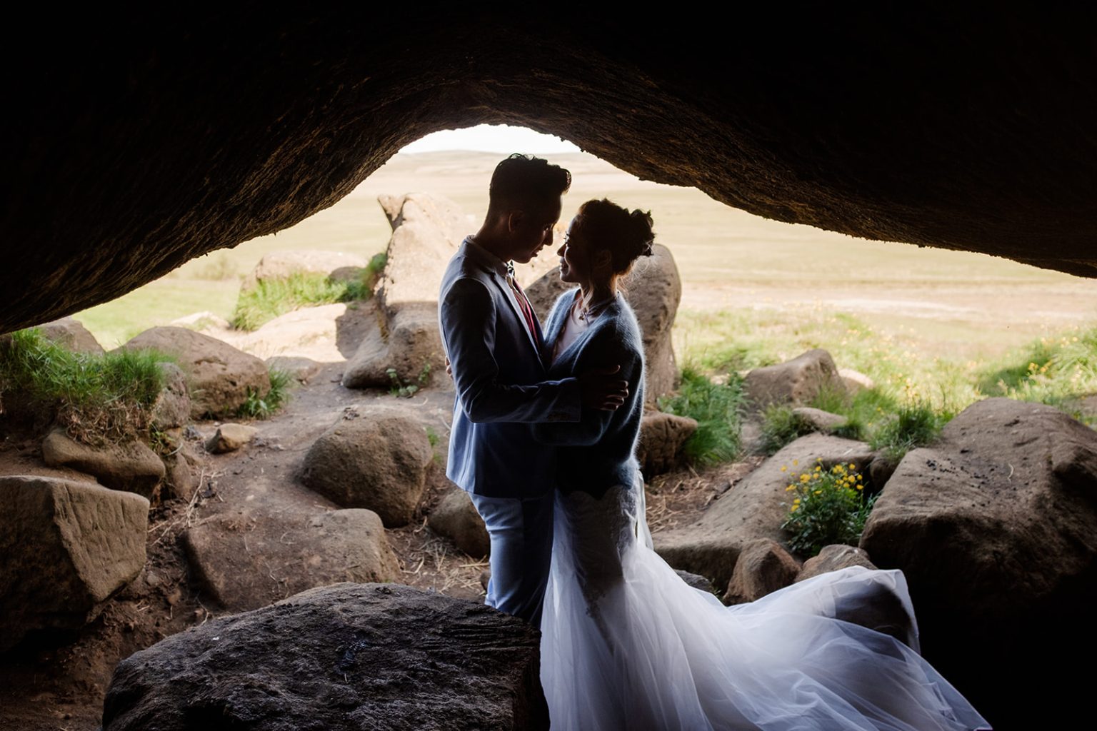 The couple silhouetted in a cave in Iceland