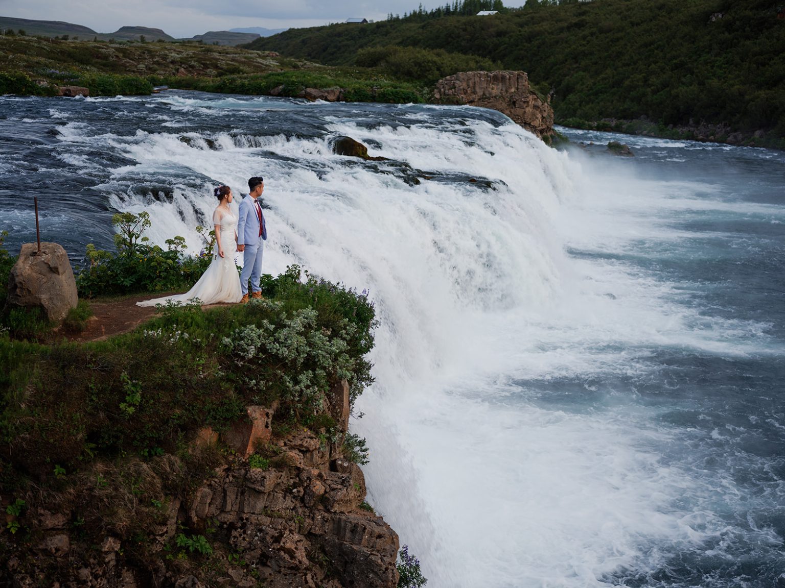 The couple beside a waterfall on the Golden Circle