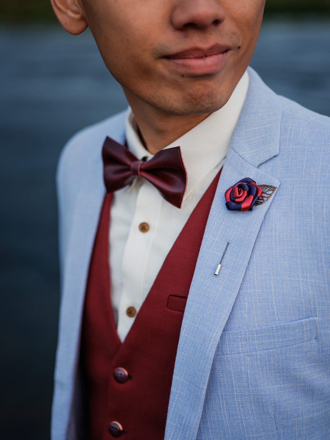 The groom's bow tie and boutonniere