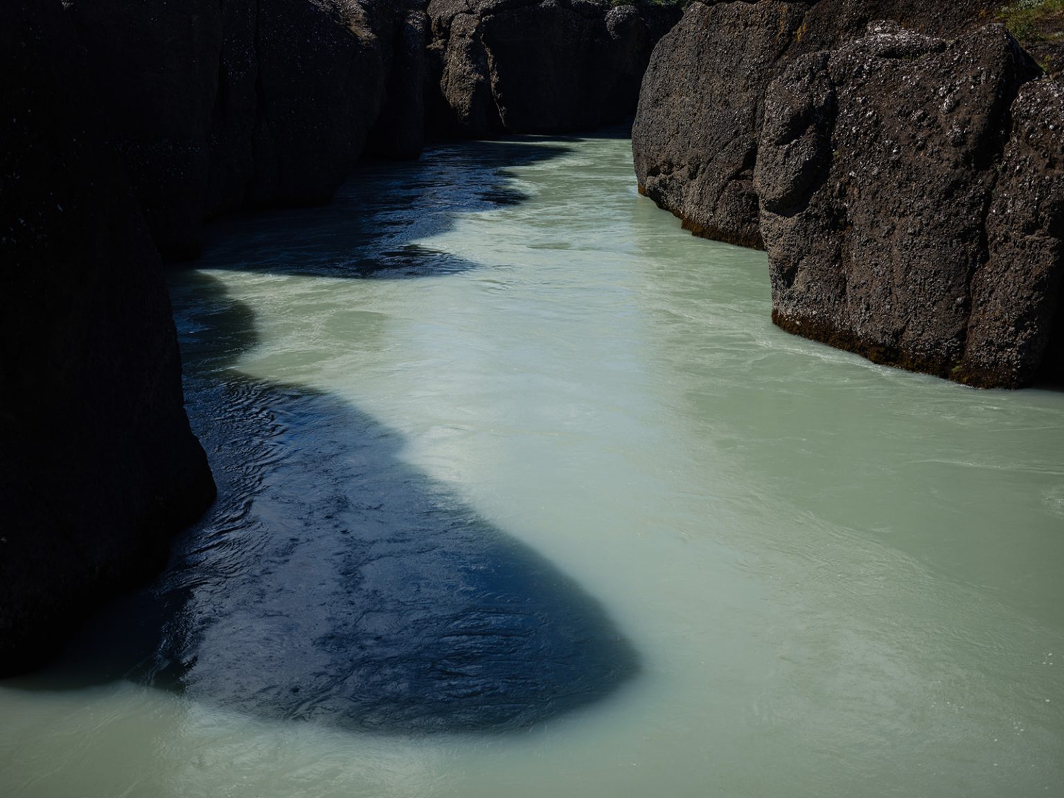 The blue glacial water of Brúarfoss