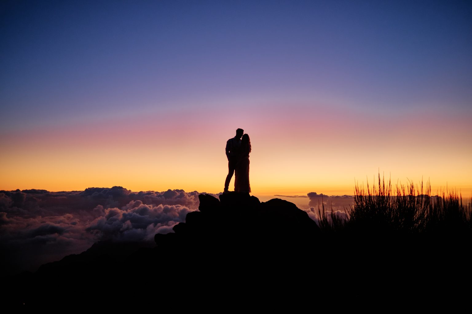 Silhouette on volcanic rock against the sunrise at Pico do Arieiro, Madeira