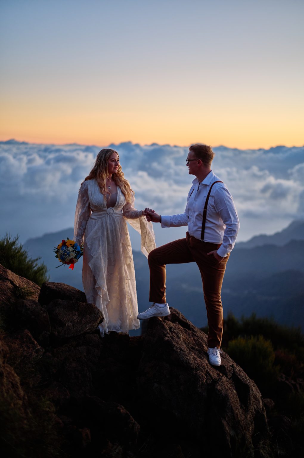 Couple with a bouquet on the ridge at sunrise, Pico do Arieiro, Madeira