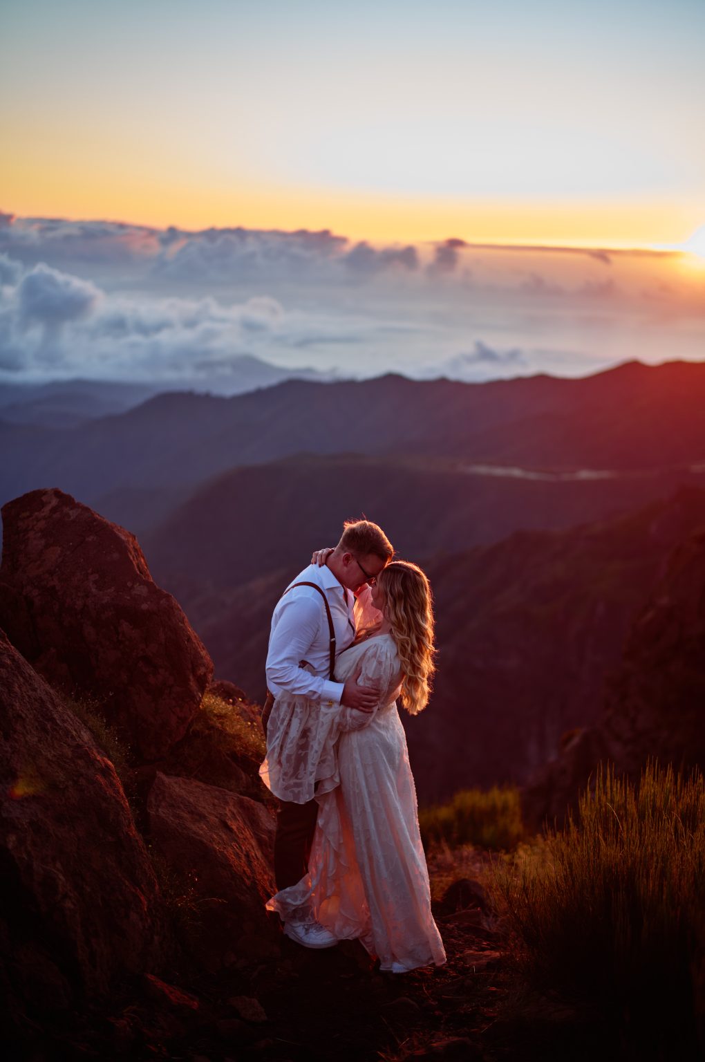 Bride and groom foreheads together at sunrise in the Madeira mountains