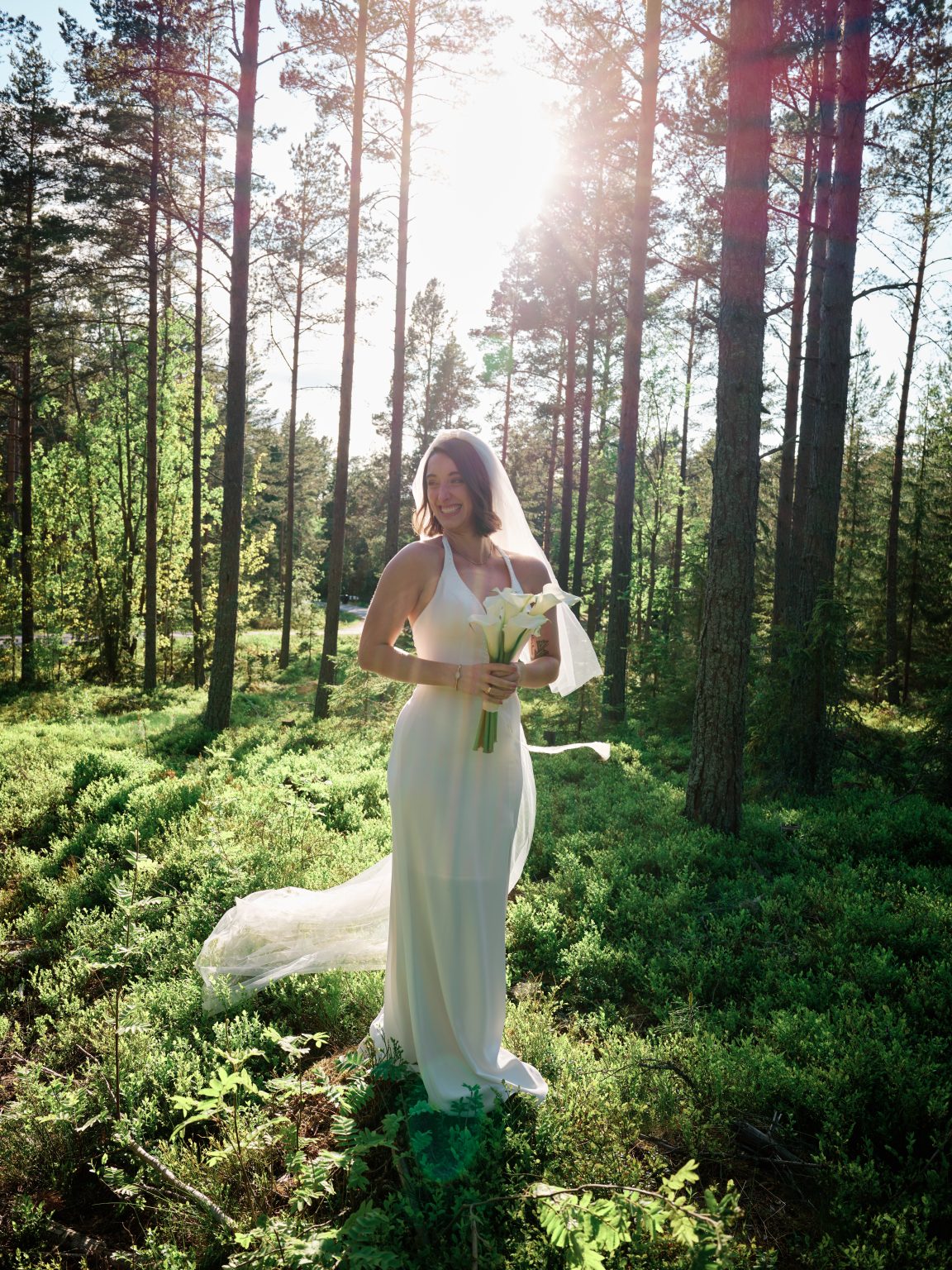 Sara in her dress among the pines at Hop Farm Beach