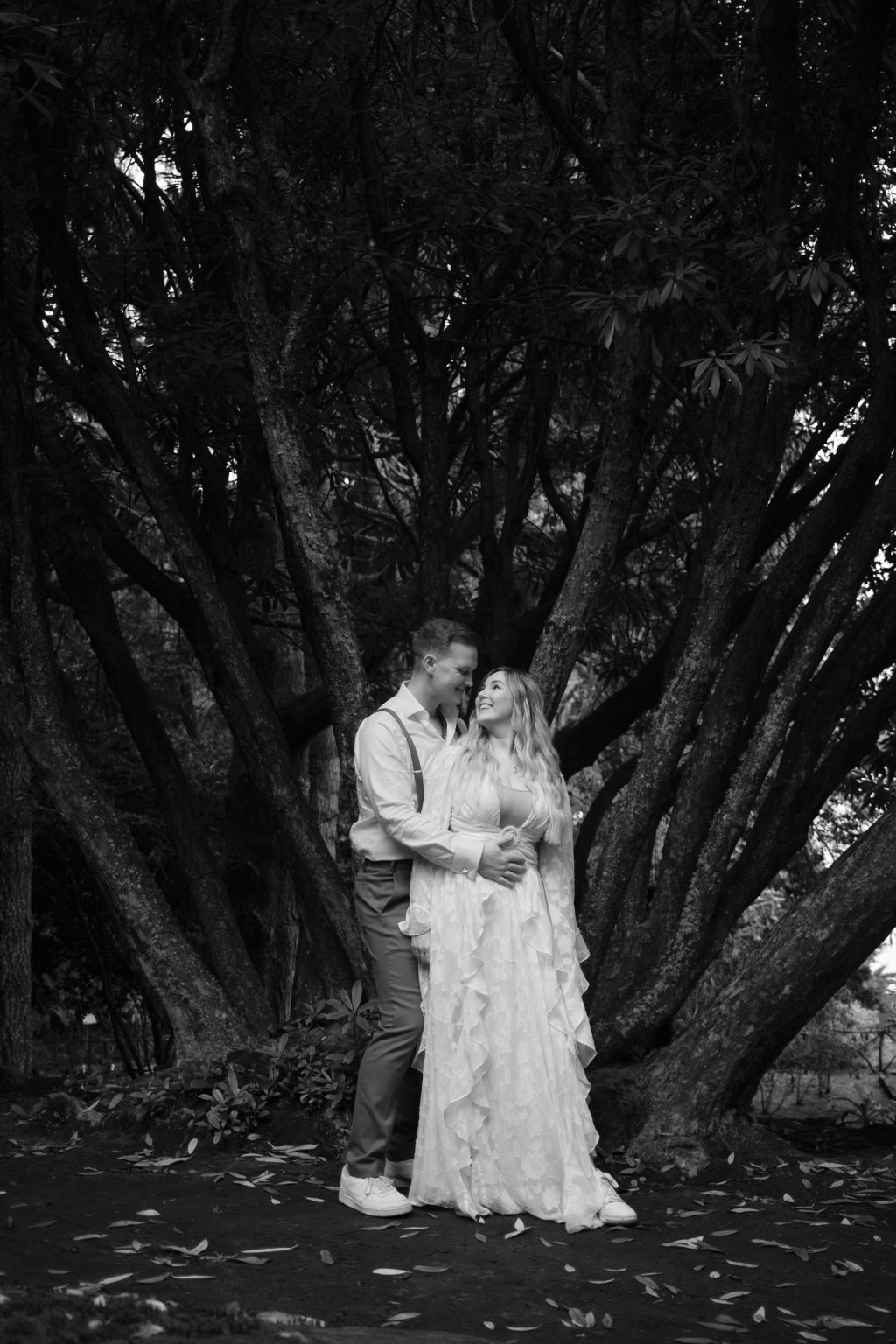 Bride beneath ancient laurel trees in the Queimadas forest, black and white, Madeira