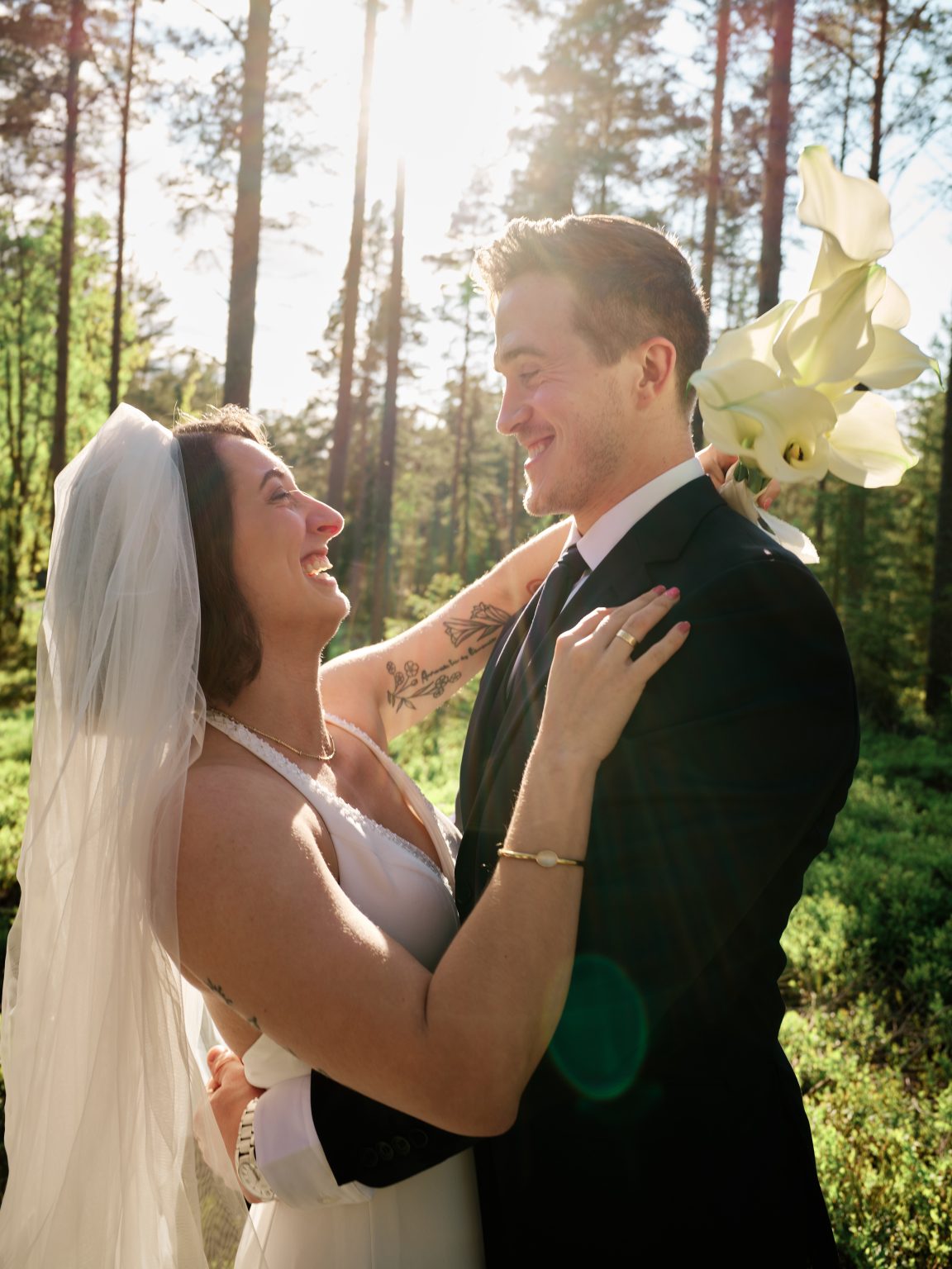 Sara laughing close to Martin, orchid bouquet in hand