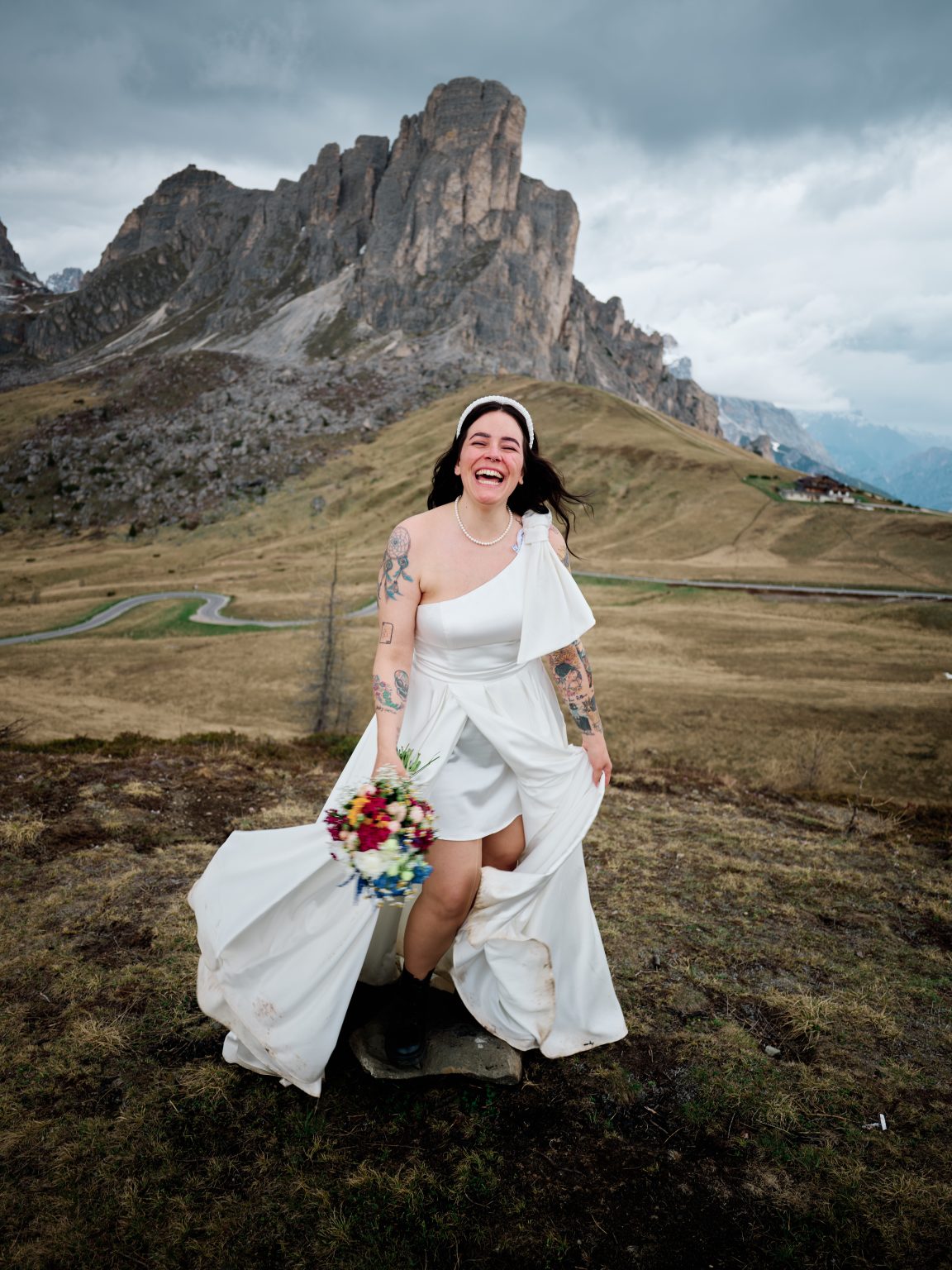 Elisa walking through the green pass at Passo Giau, Dolomites engagement session