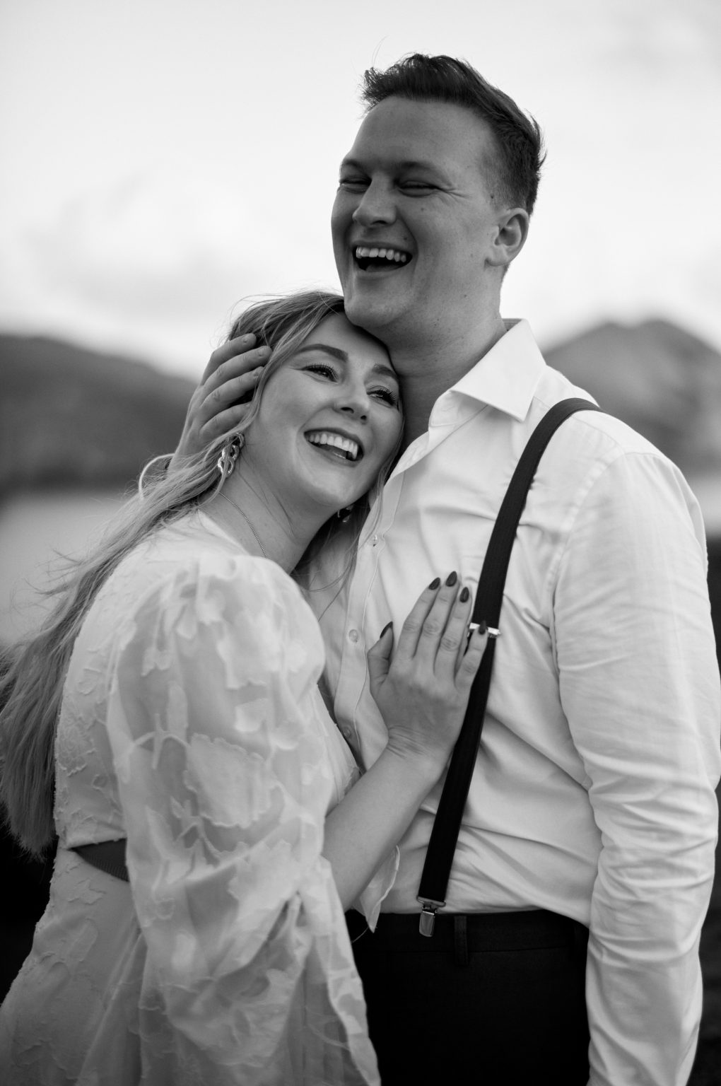 Bride and groom laughing together on the coast, black and white, Madeira