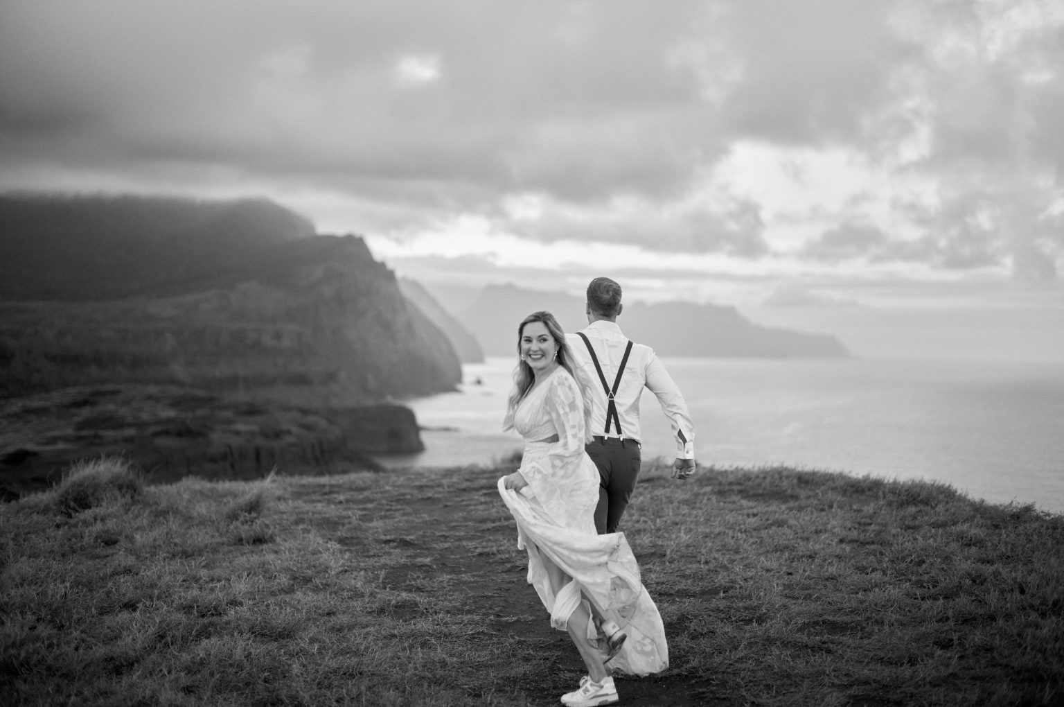 Couple walking the windswept ridge at sunset in black and white, Ponta de Sao Lourenco, Madeira
