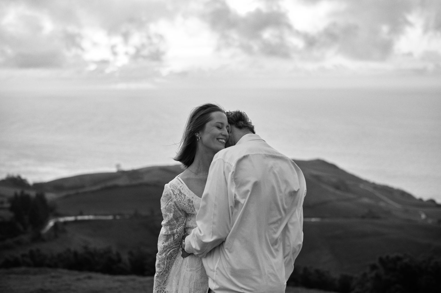 Embracing above the coastline of São Miguel during their Azores elopement