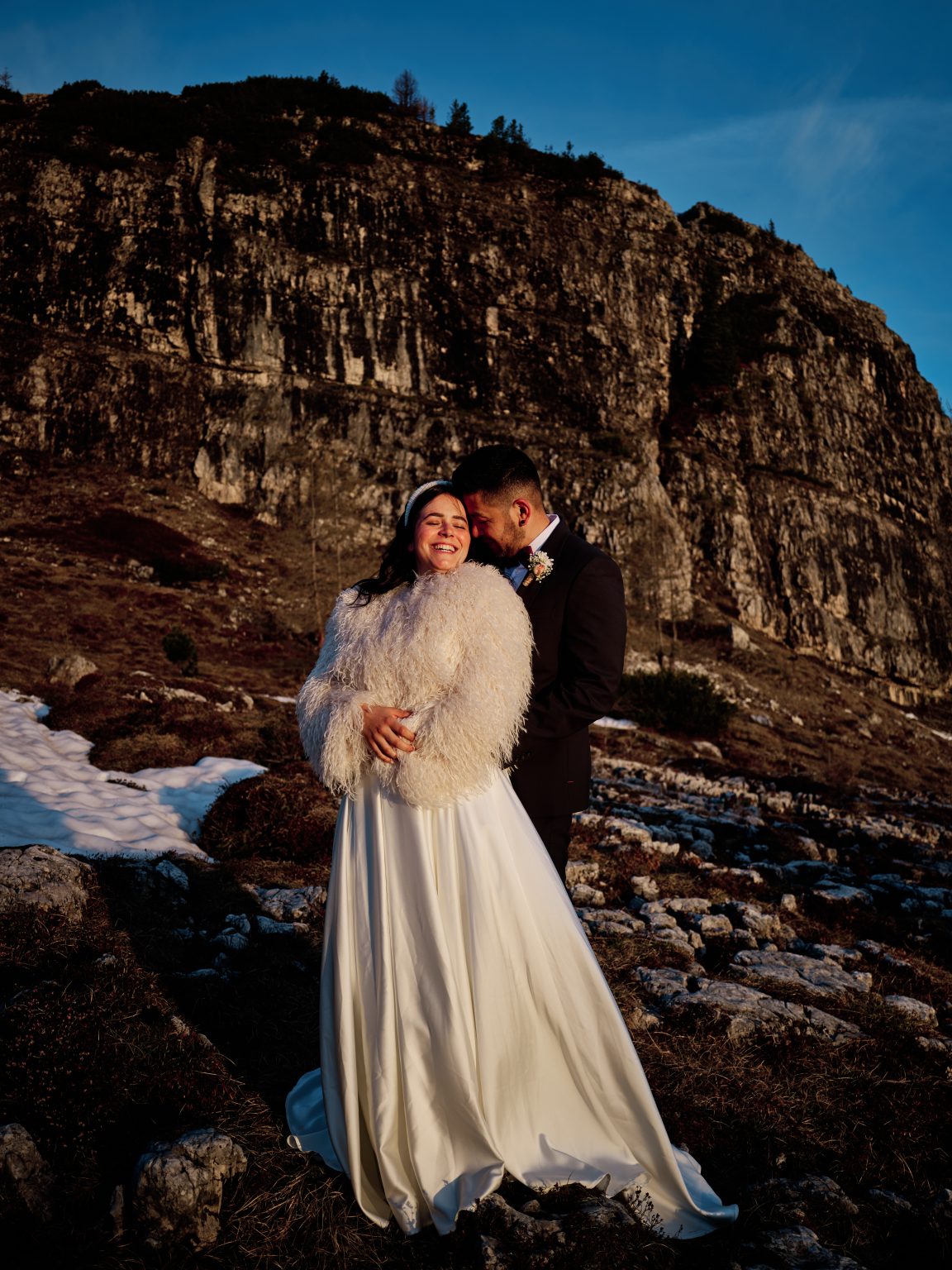 Elisa and Hector cheek to cheek at Cinque Torri, Dolomites engagement session at sunrise