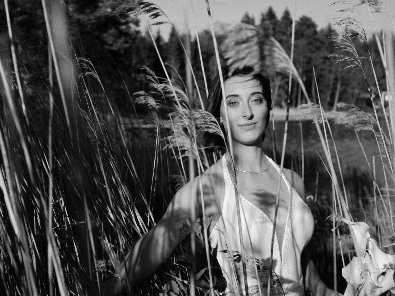 Sara through the tall reeds in black and white on the Baltic coast