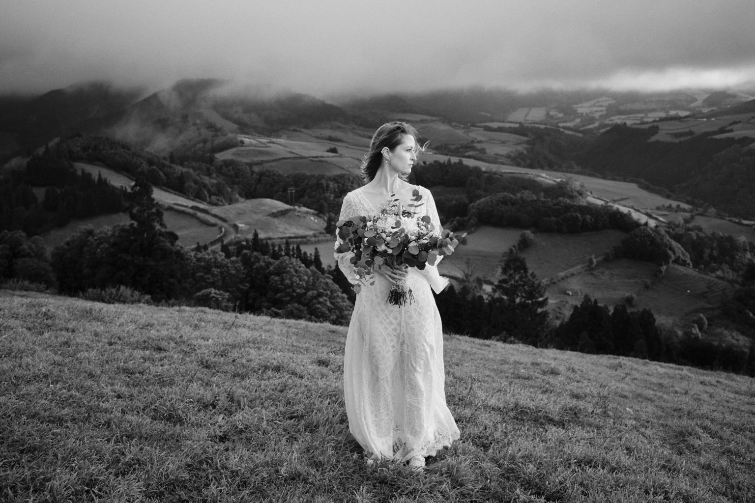 Bride with her bouquet in the patchwork hills of São Miguel