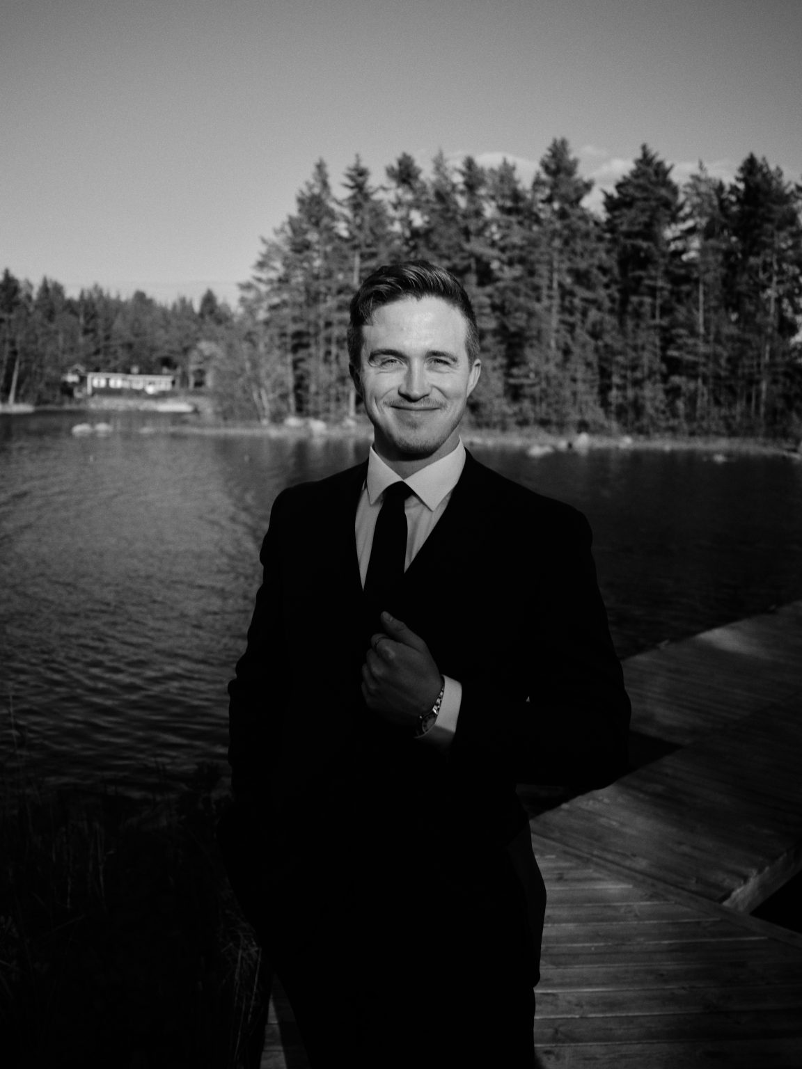 Martin in a black suit at the shoreline of the Baltic