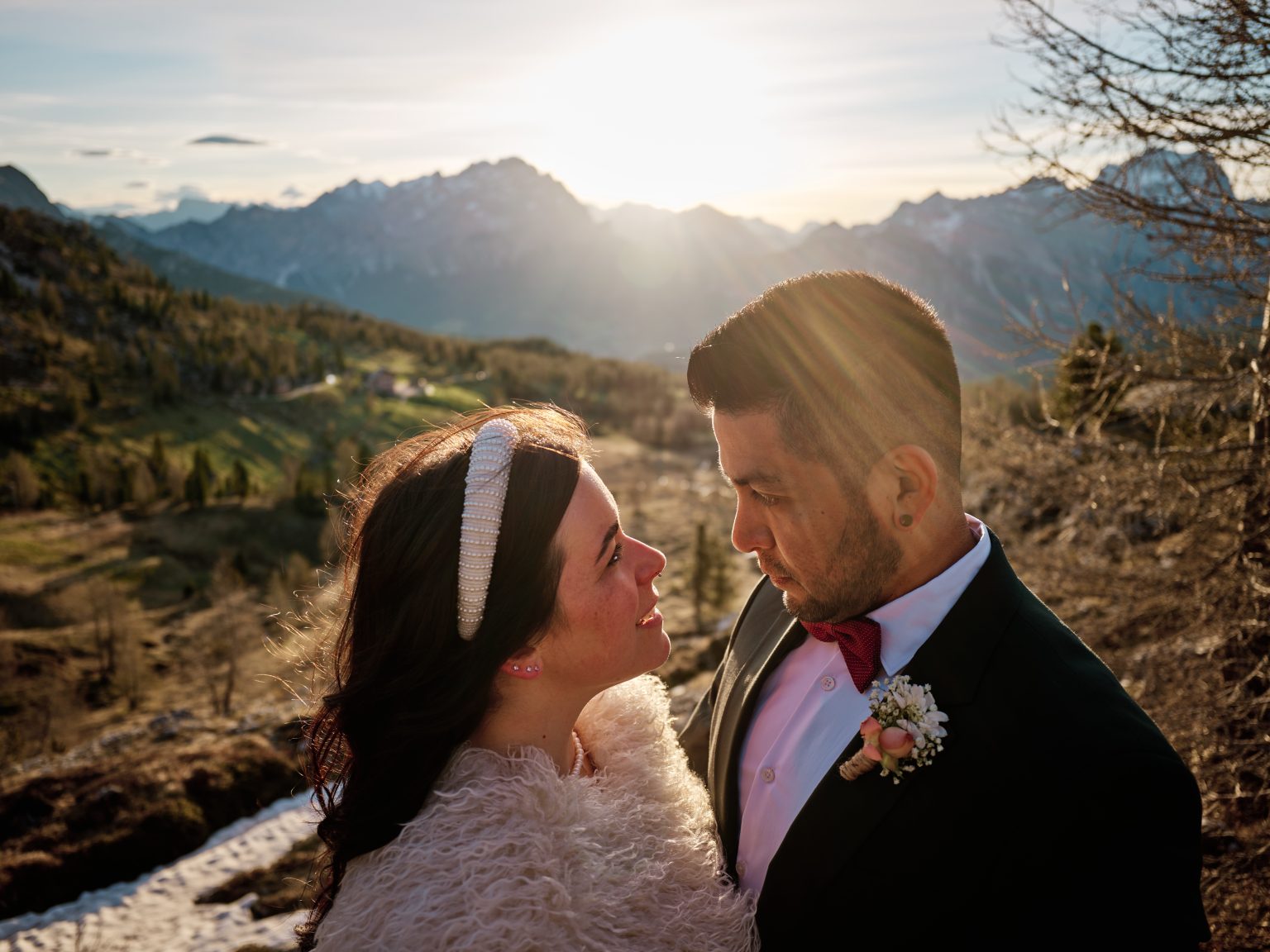 Elisa and Hector with the sun breaking between them at a Dolomites sunrise