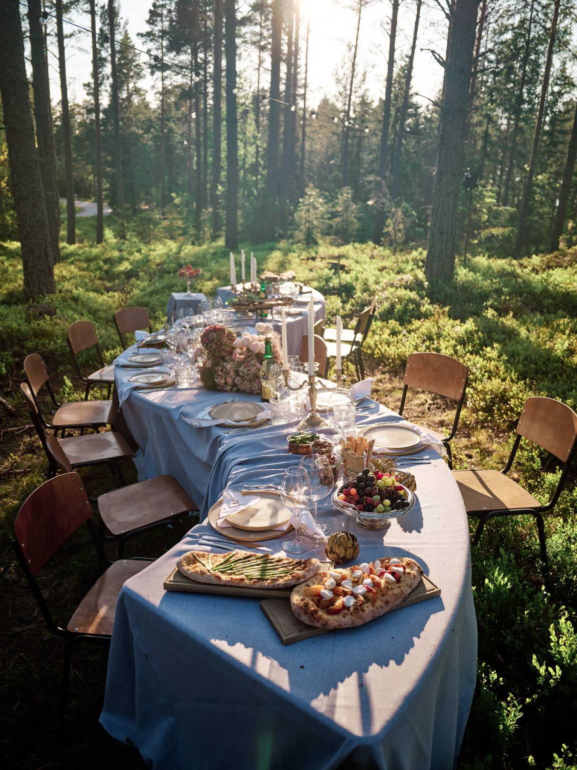 The forest wedding table set in blue linen at Hop Farm Beach