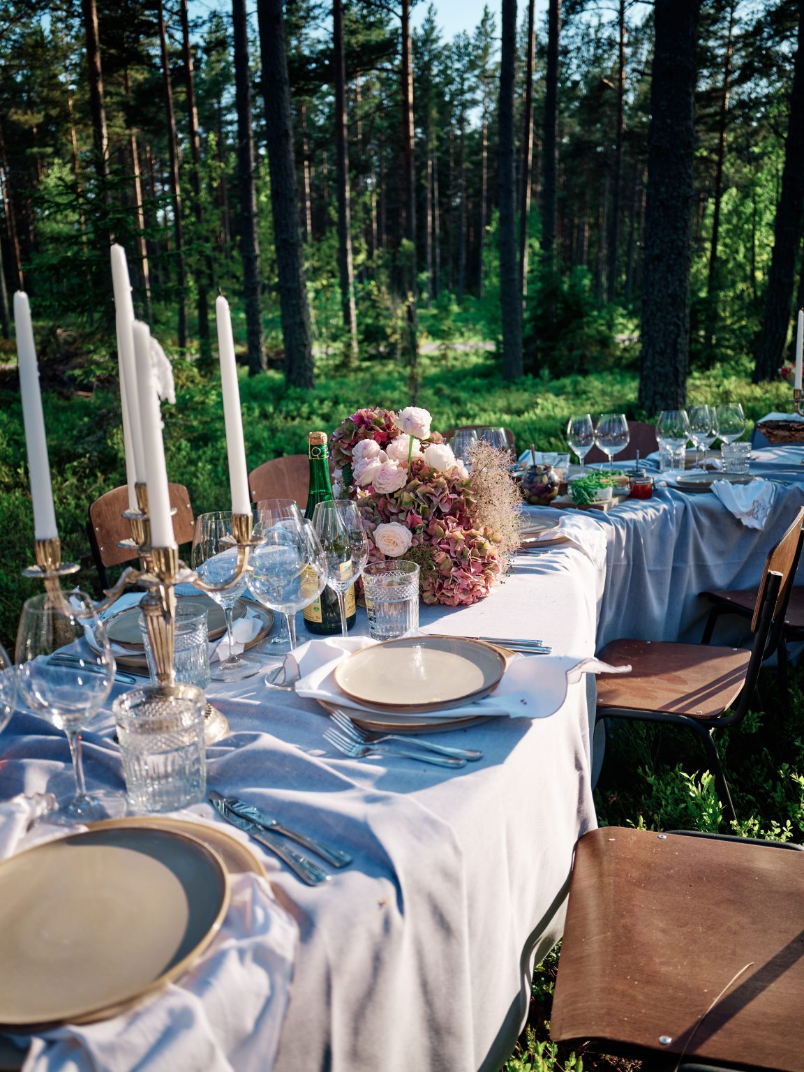 Candles and a rose centrepiece on the elopement table in the forest