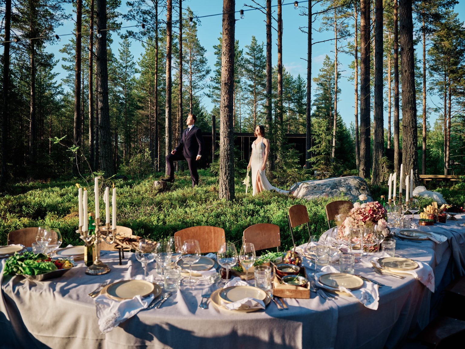 The wedding table through the trees at Hop Farm Beach