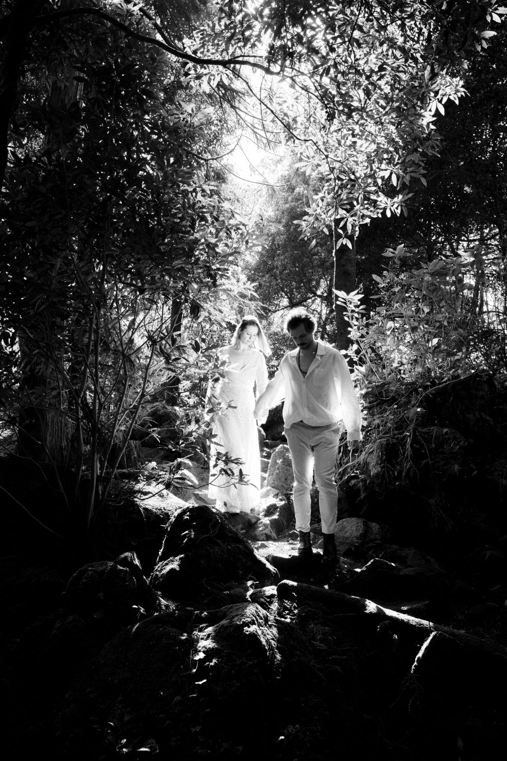 Walking hand in hand through the forest light of São Miguel