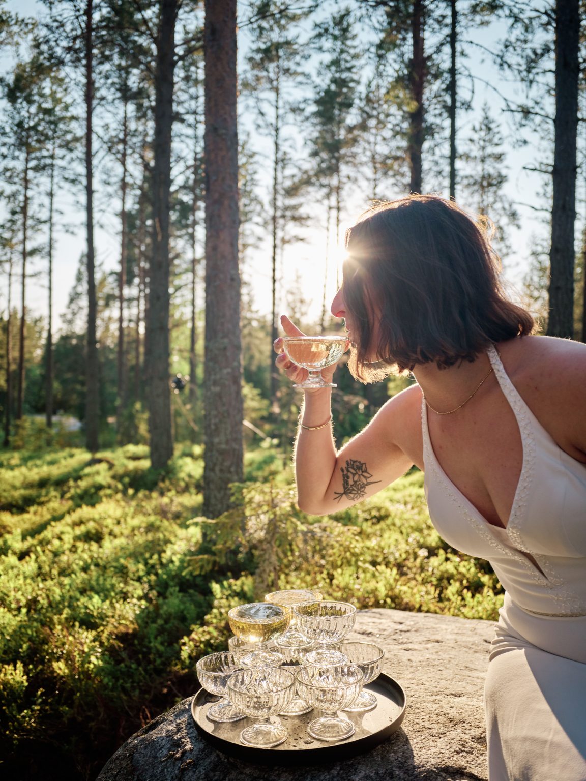 Sara with a glass of champagne in the evening sun