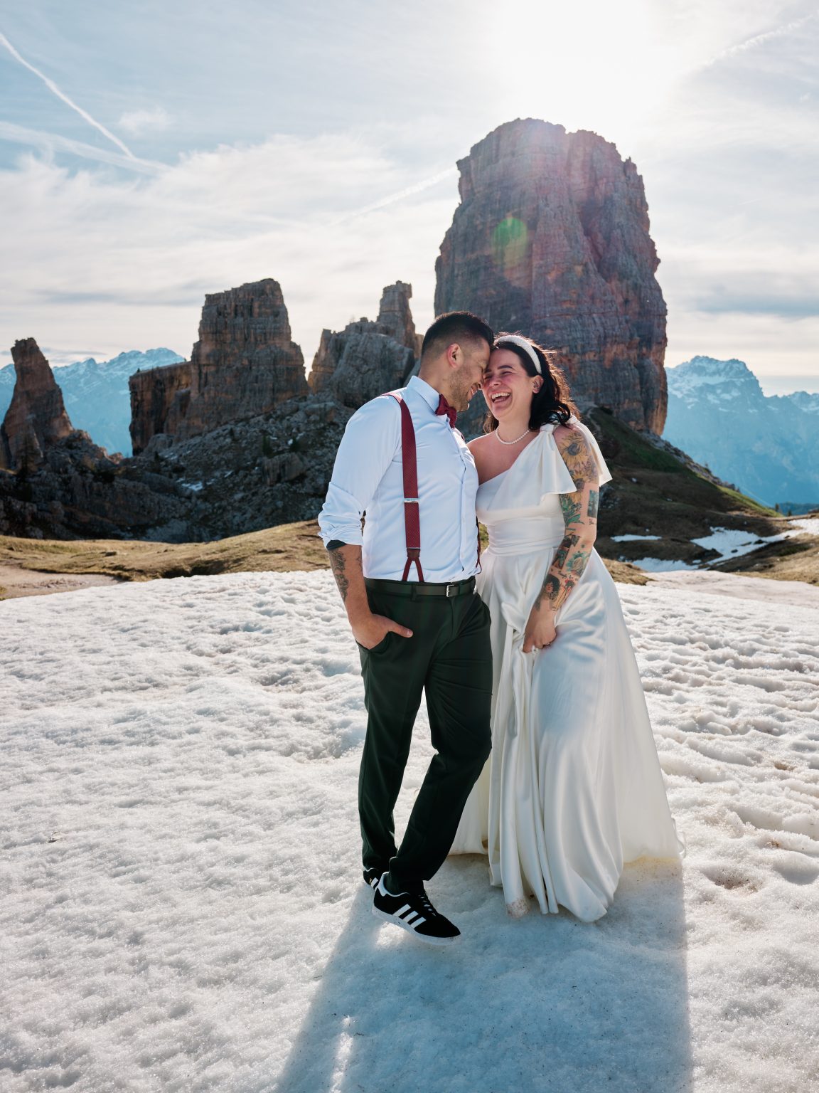Elisa and Hector close together below the Cinque Torri towers, snow underfoot