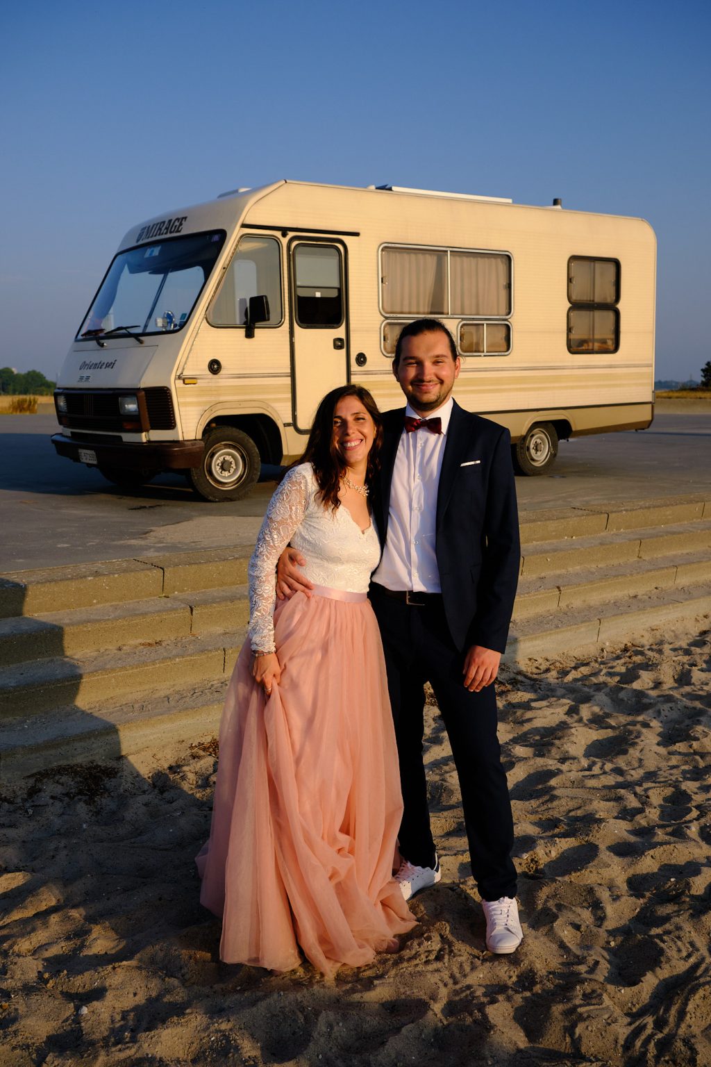 Irene and Jan on the steps of their caravan, dressed for their elopement session