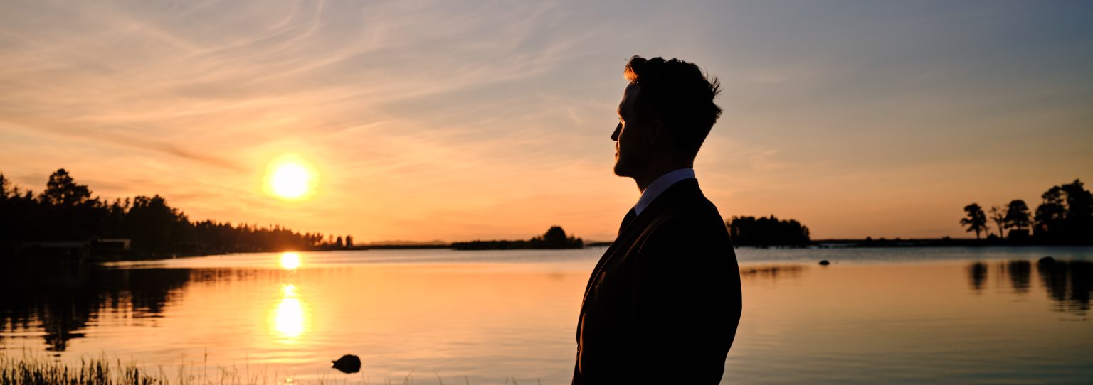 Martin silhouetted against the sunset over the Baltic