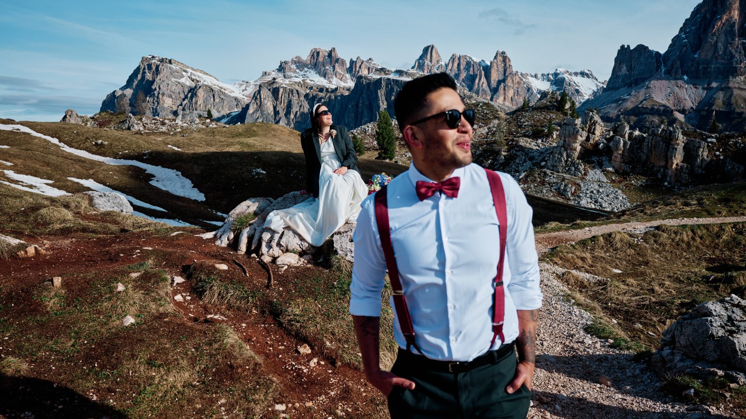 Hector in braces and sunglasses celebrating with Elisa in the Dolomites