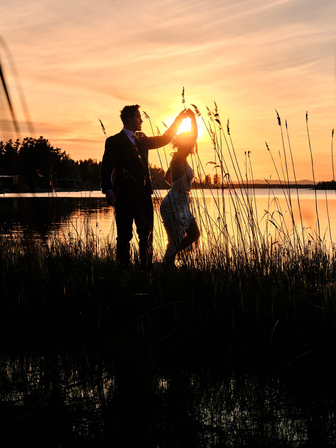 Sara and Martin walking hand in hand through the reeds at sunset, Hop Farm Beach