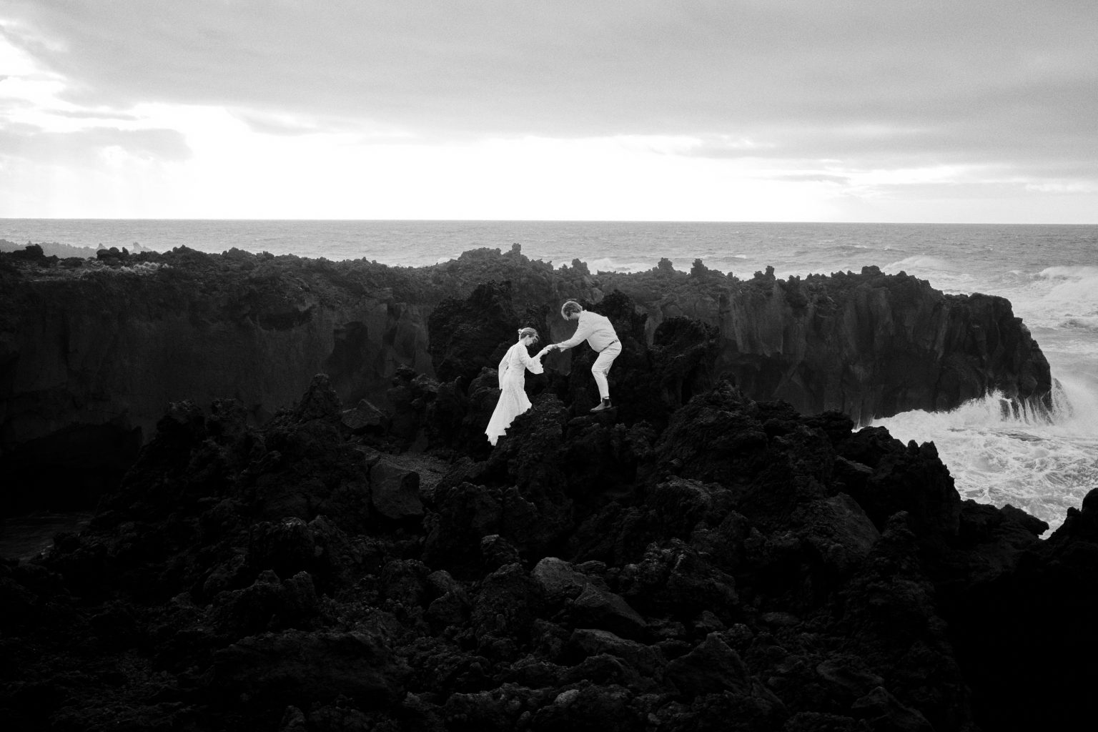 Climbing the lava rocks above the surf on São Miguel