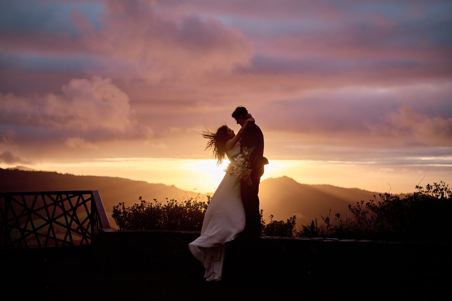 Bride and groom embracing at first light on the Miradouro do Salto do Cavalo, São Miguel
