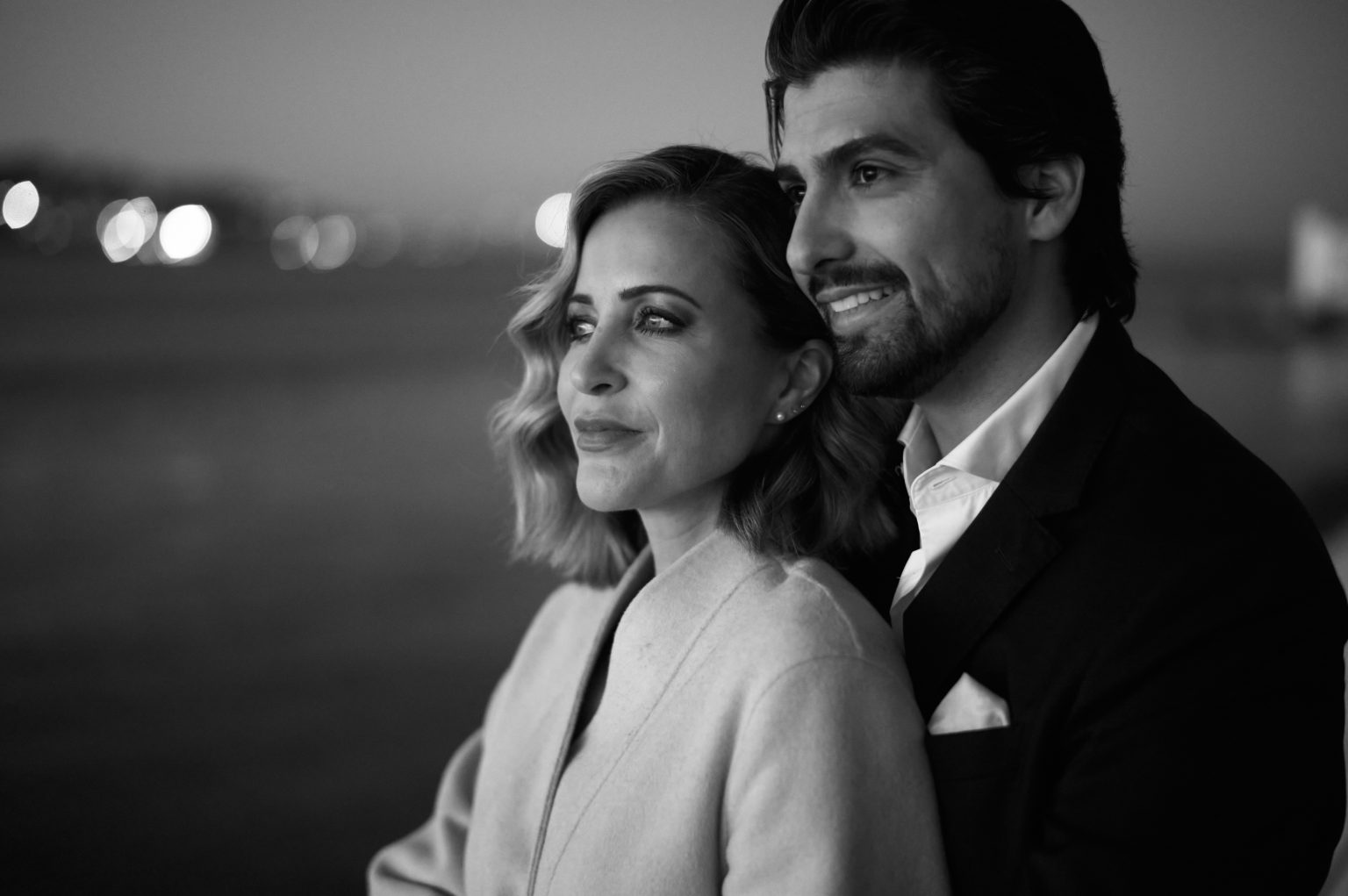 Black and white portrait of Ana and David at blue hour on the Lisbon waterfront