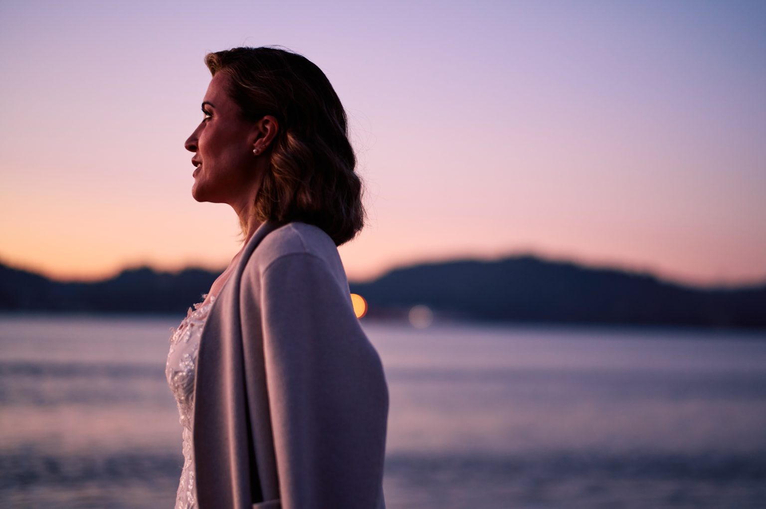 Portrait of Ana at blue hour beside the Tejo river in Lisbon