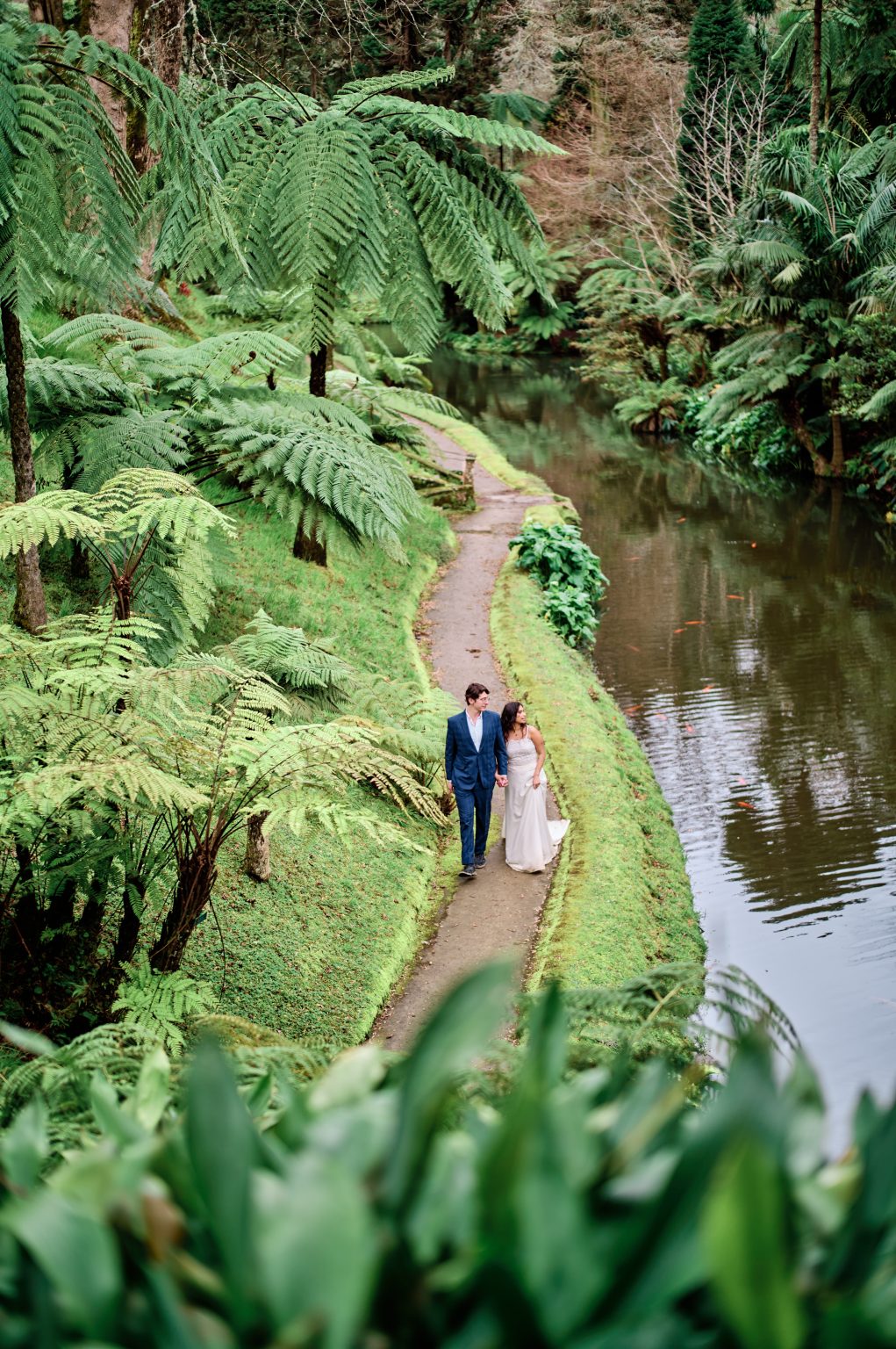 Couple on a fern-lined path at Parque Terra Nostra, São Miguel, Azores