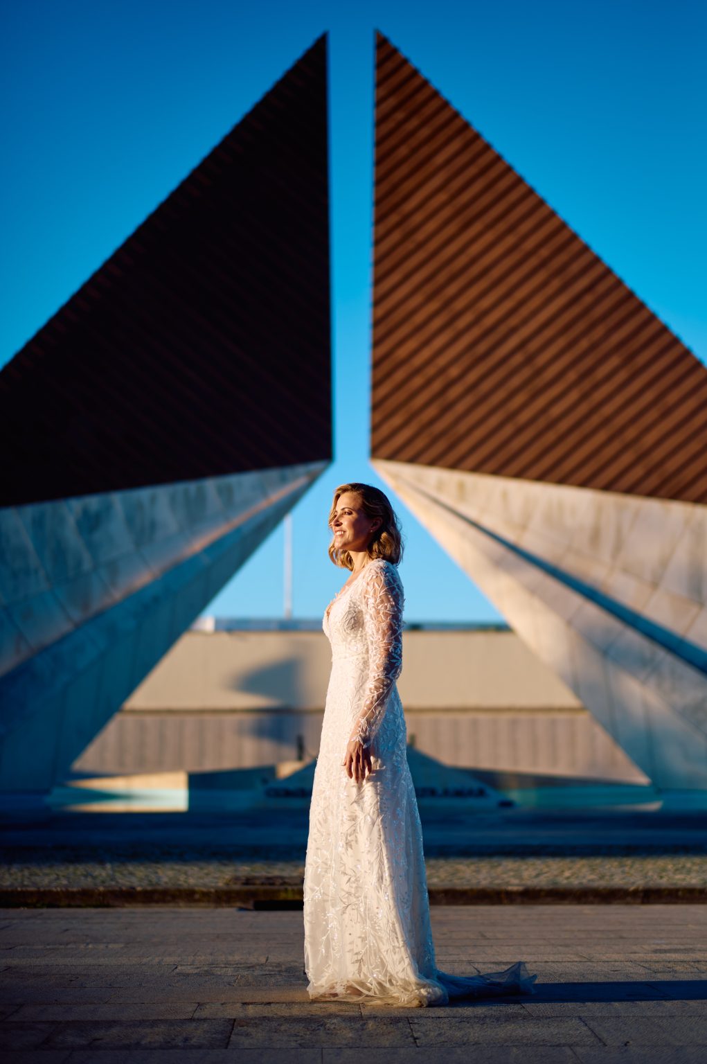 Ana framed by modern architecture in Belém during a Lisbon couple session