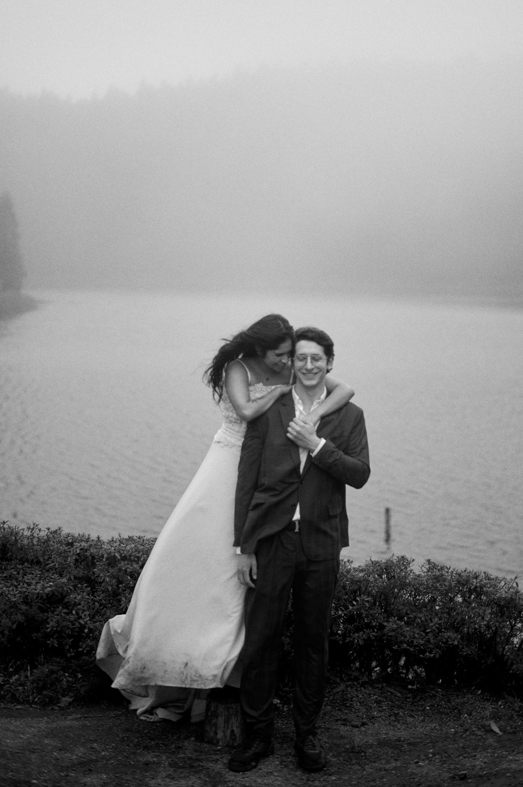 Couple close together against the weather in black and white, São Miguel, Azores