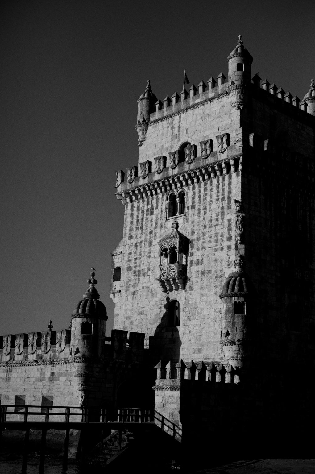 The Torre de Belém in black and white against a dark sky