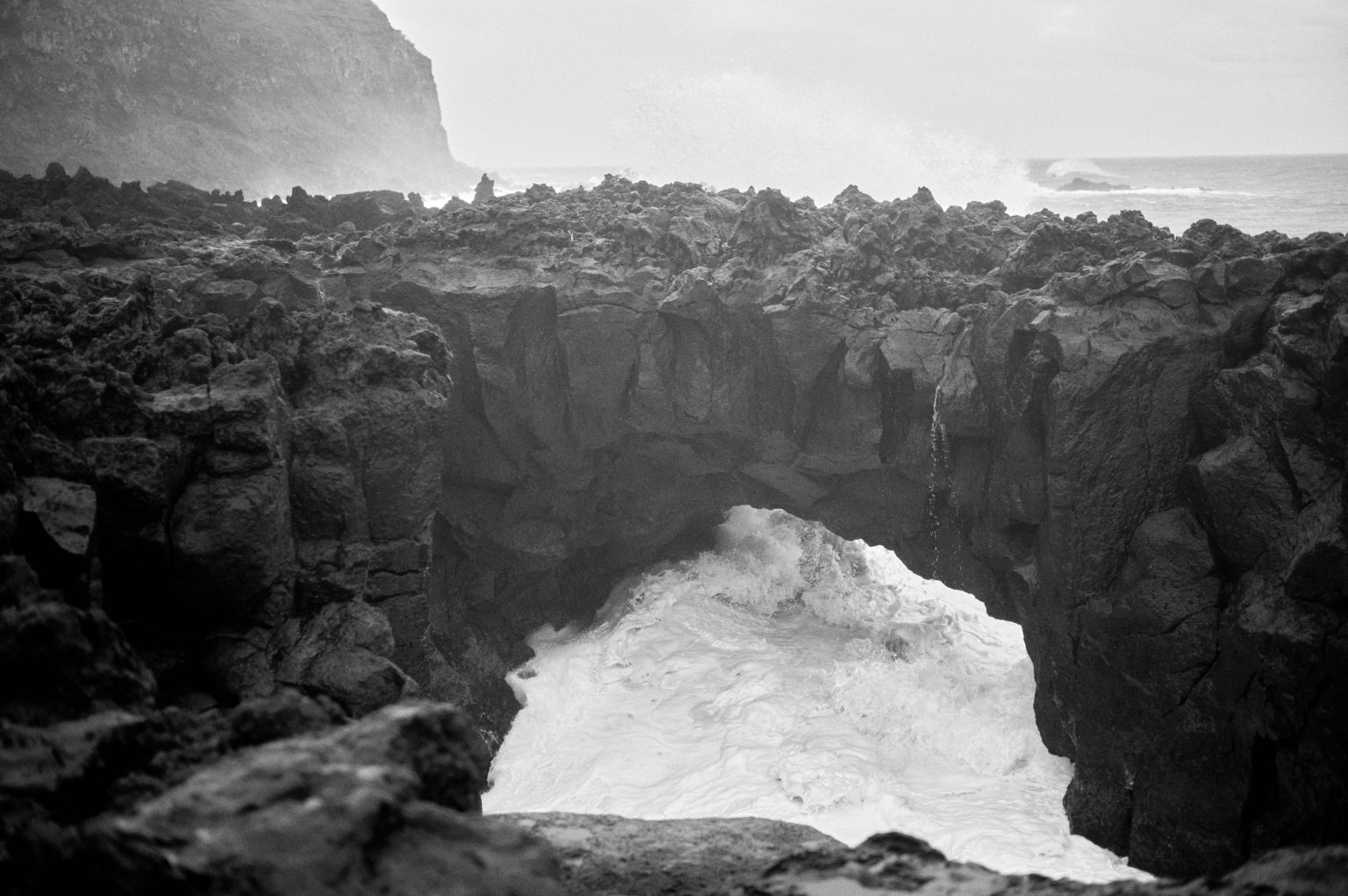 The lava arch known as A Porta do Diabo at Ponta da Ferraria in black and white, São Miguel