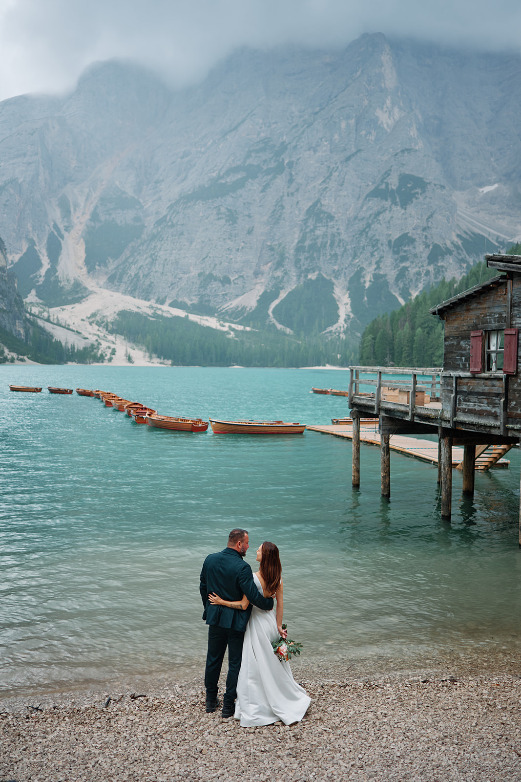 Couple at the Lago di Braies boathouse, Dolomites