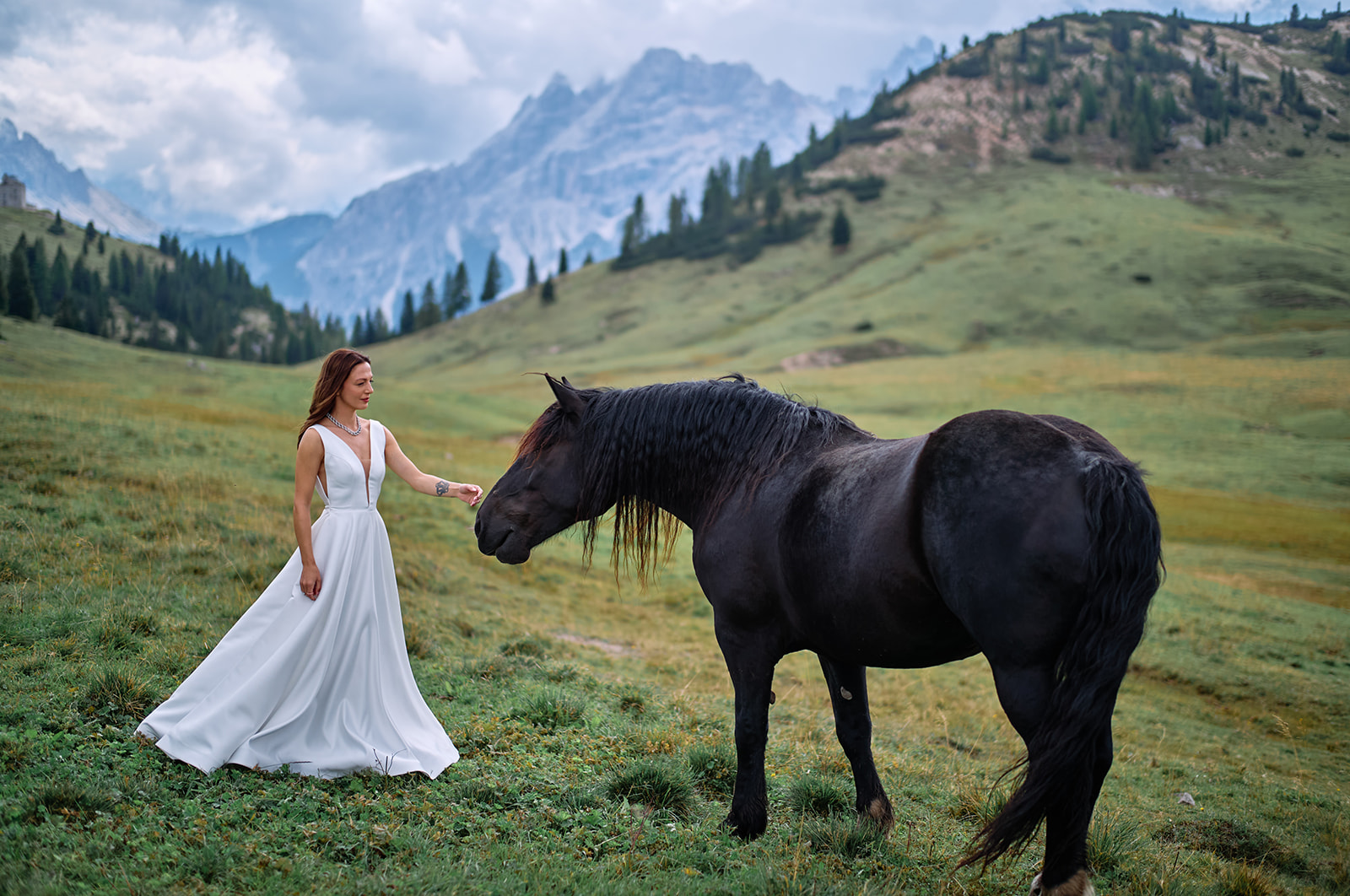 Bride with wild horses at Prato Piazza, Dolomites